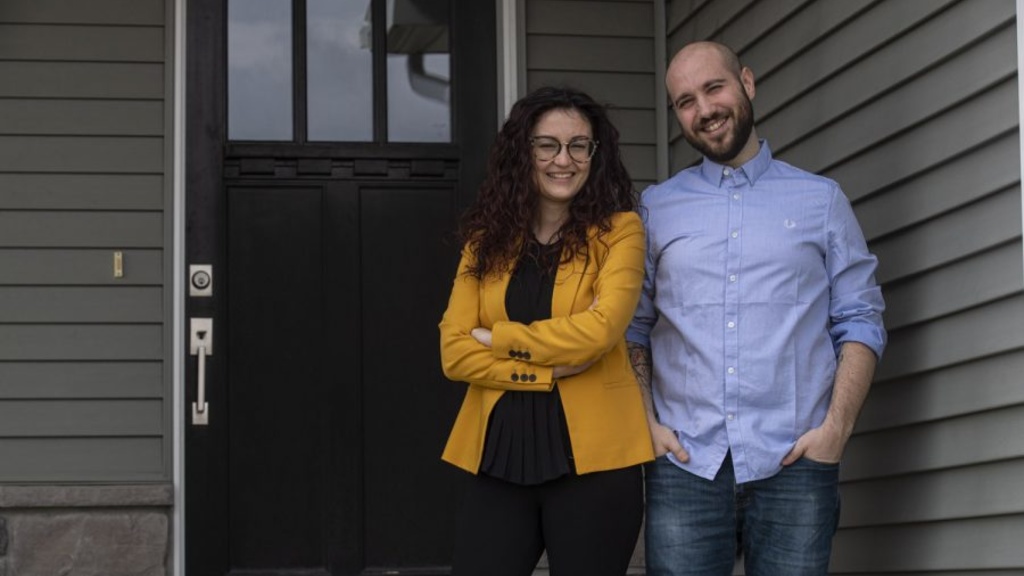 Caterina Lamuta and Venanzio Cichella pose for a photo in front of their house